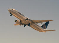 Stock Photo titled: Airplane in the air -- Beoing 737 Continental in the setting sun